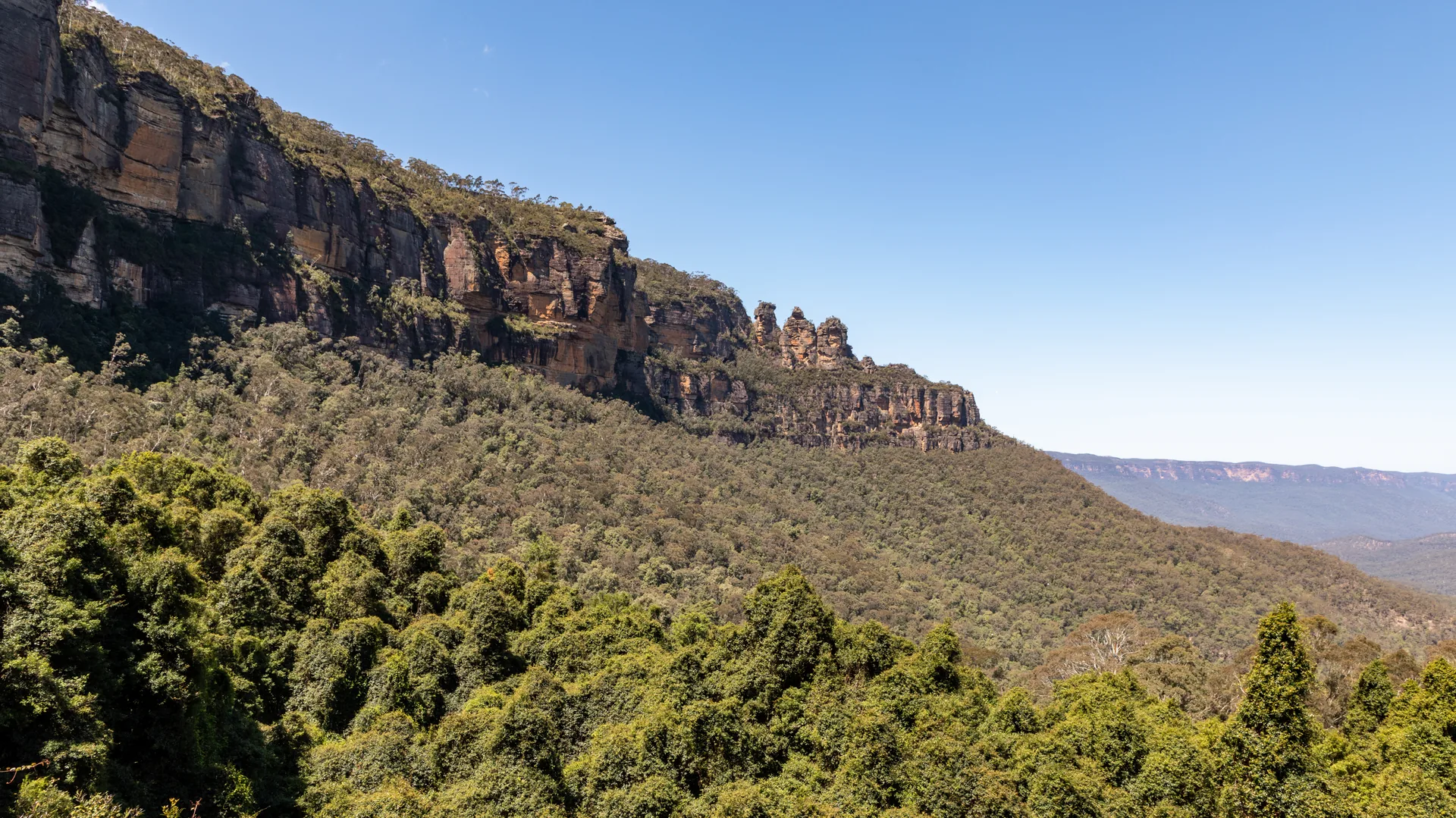 The Three Sisters rock formation and blue-hazed valleys of the Blue Mountains